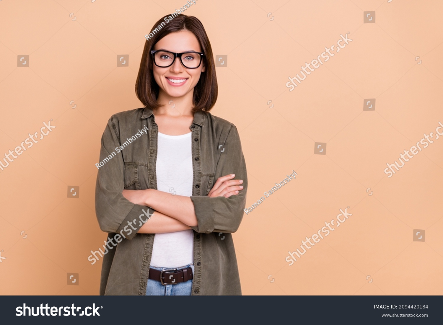 Photo of self-assured freelancer lady crossed arms wear eyeglasses khaki shirt isolated beige color background #2094420184