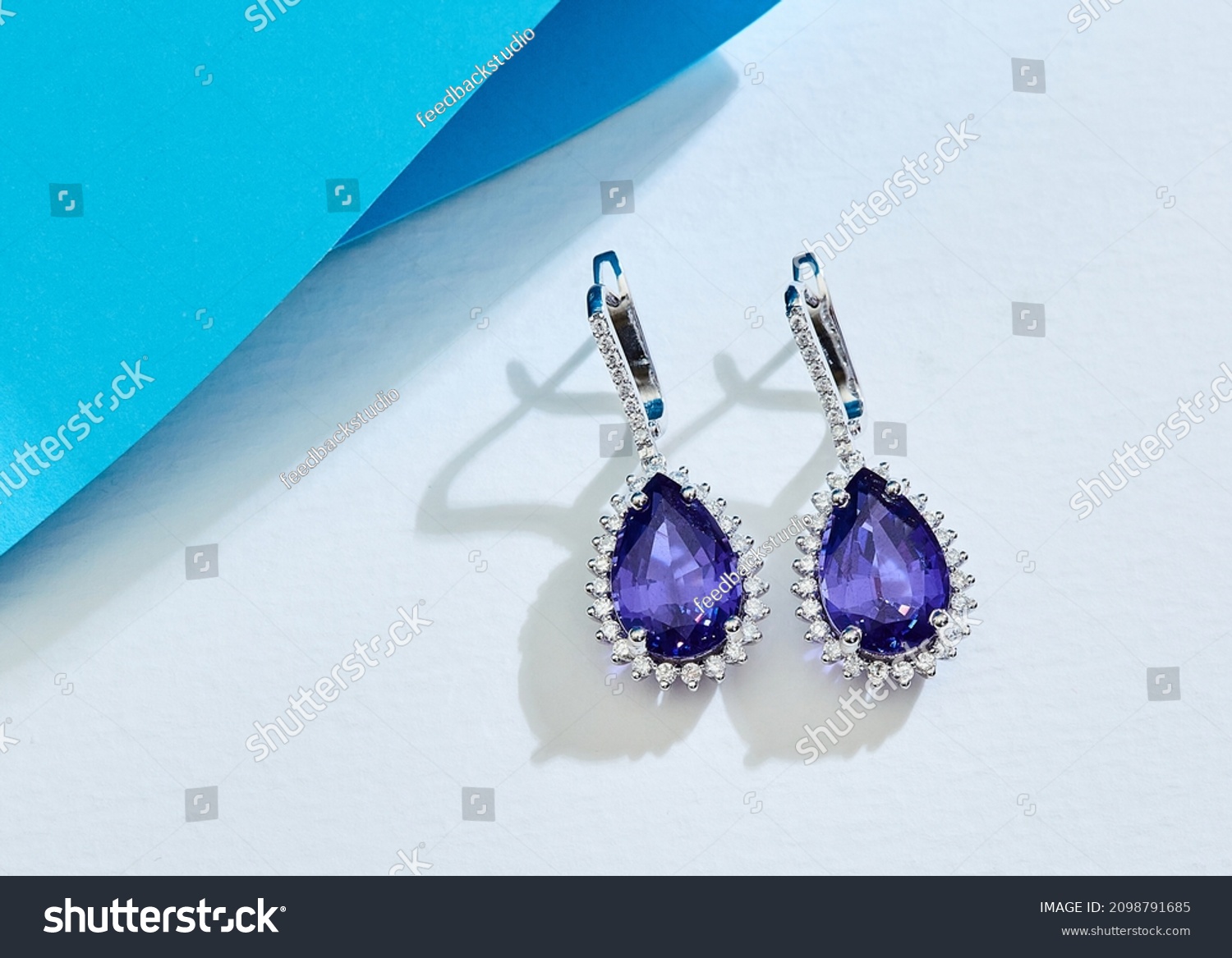 Diamond jewelry. Diamond sapphire earrings on background #2098791685