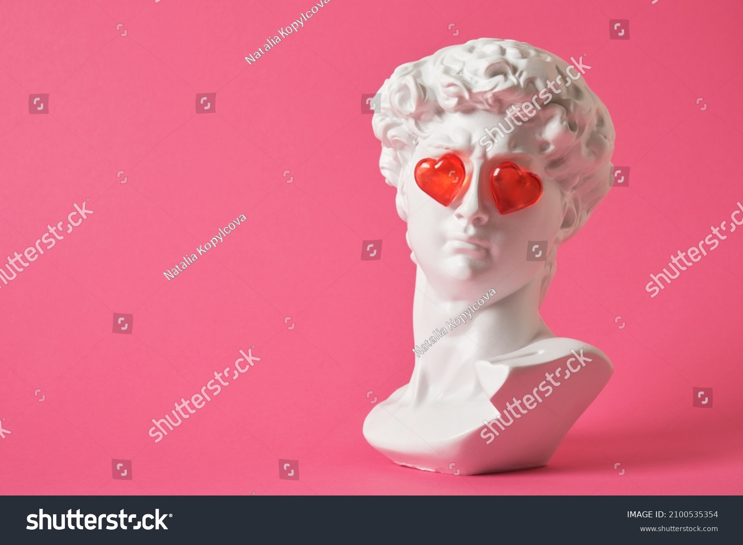 fake bust of david with red glass hearts on the eyes, love concept, valentine's day congratulations #2100535354