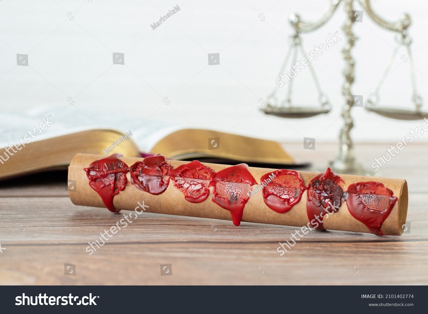 A closeup of an ancient closed scroll with seven seals on a wooden table with Holy Bible Book and old weighing scales against a white background. Christian biblical concept of Revelation's prophecy. #2101402774