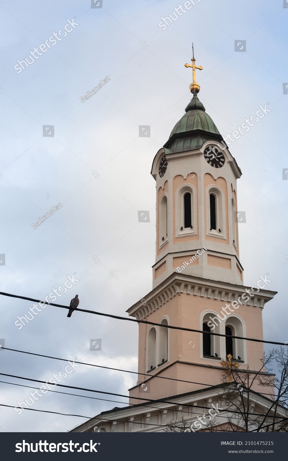Close up on Church clocktower steeple of the serbian orthodox church of Crkva svetog duha, church of the holy spirit, in Obrenovac, Serbia with its iconic clock indicating the time.  #2101475215