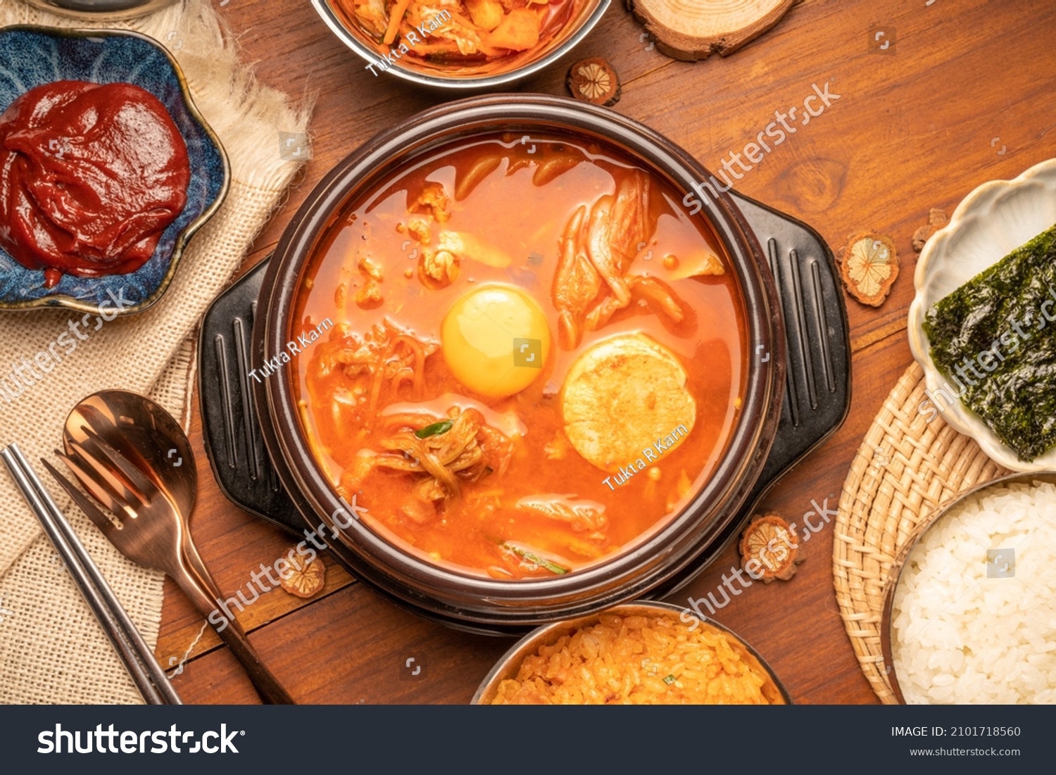 Kimchi stew or Kimchi soup, Korea’s national dish spicy soup with vegetable, meat, eggs, tofu served in a hot pot. Kimchi Jjigae korean trditional food. #2101718560