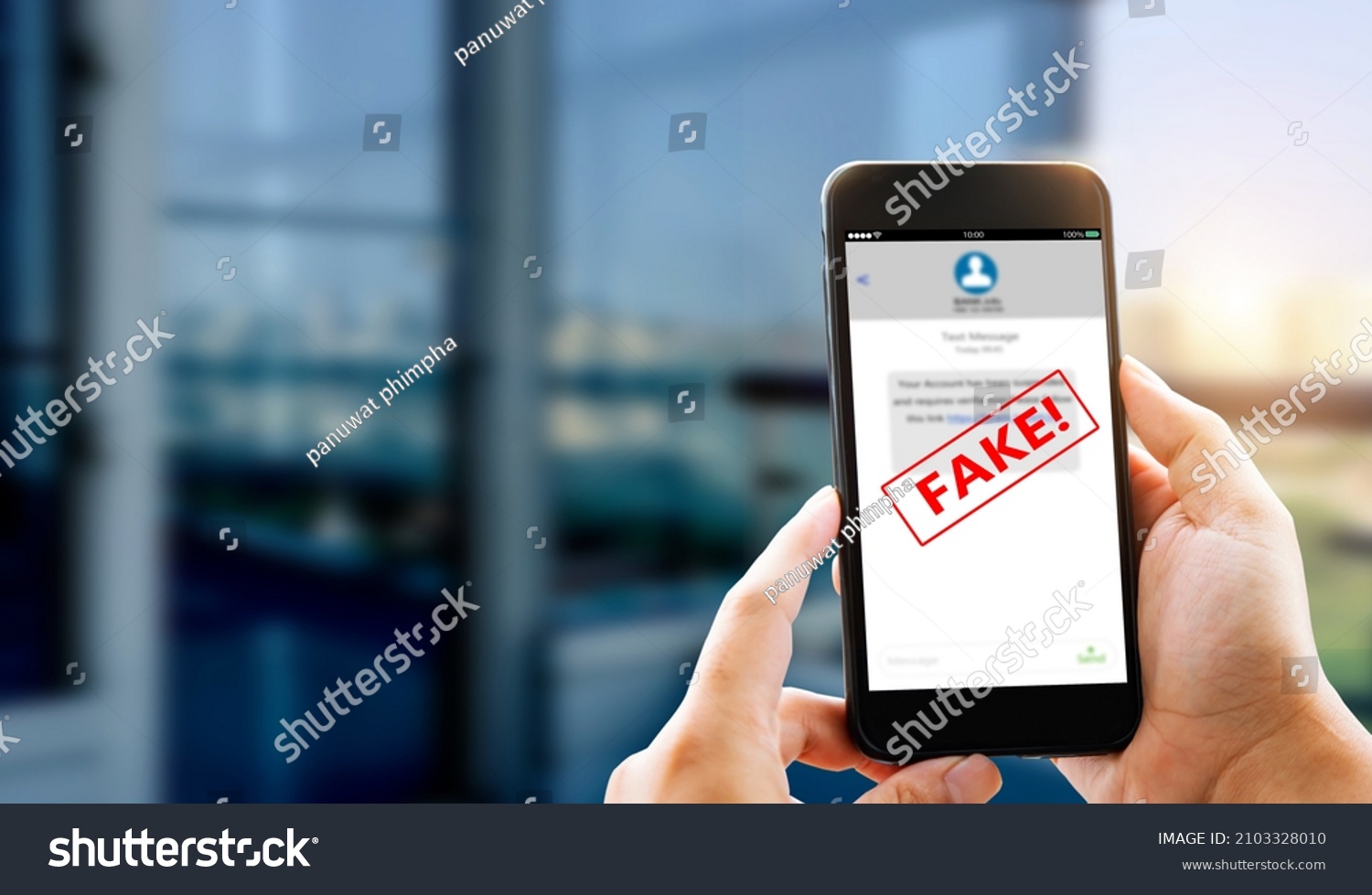 Fake Text message SMS scam or phishing concept. Man hands using smart phone #2103328010