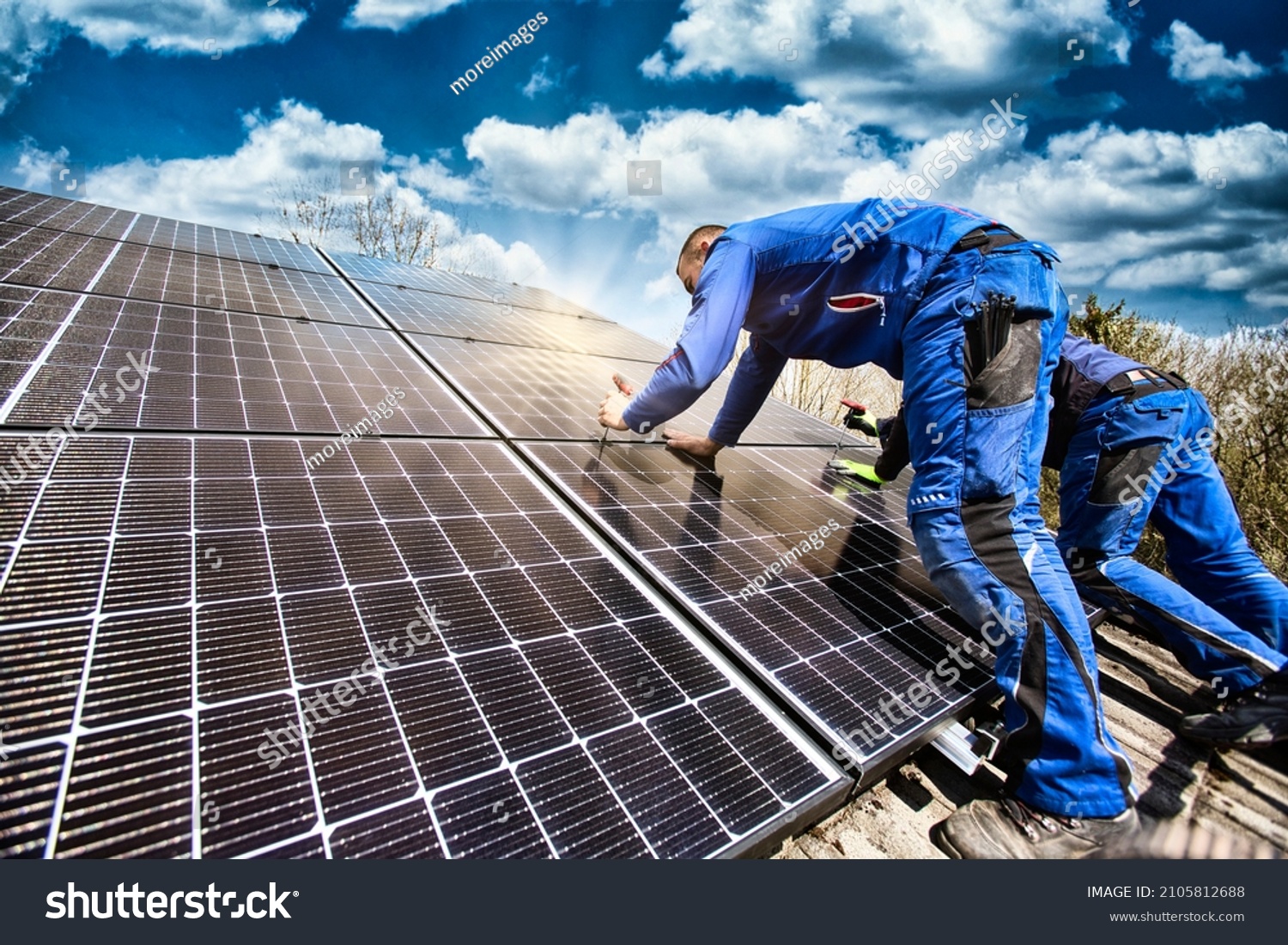 Installing solar photovoltaic panel system. Solar panel technician installing solar panels on roof. Alternative energy ecological concept. #2105812688