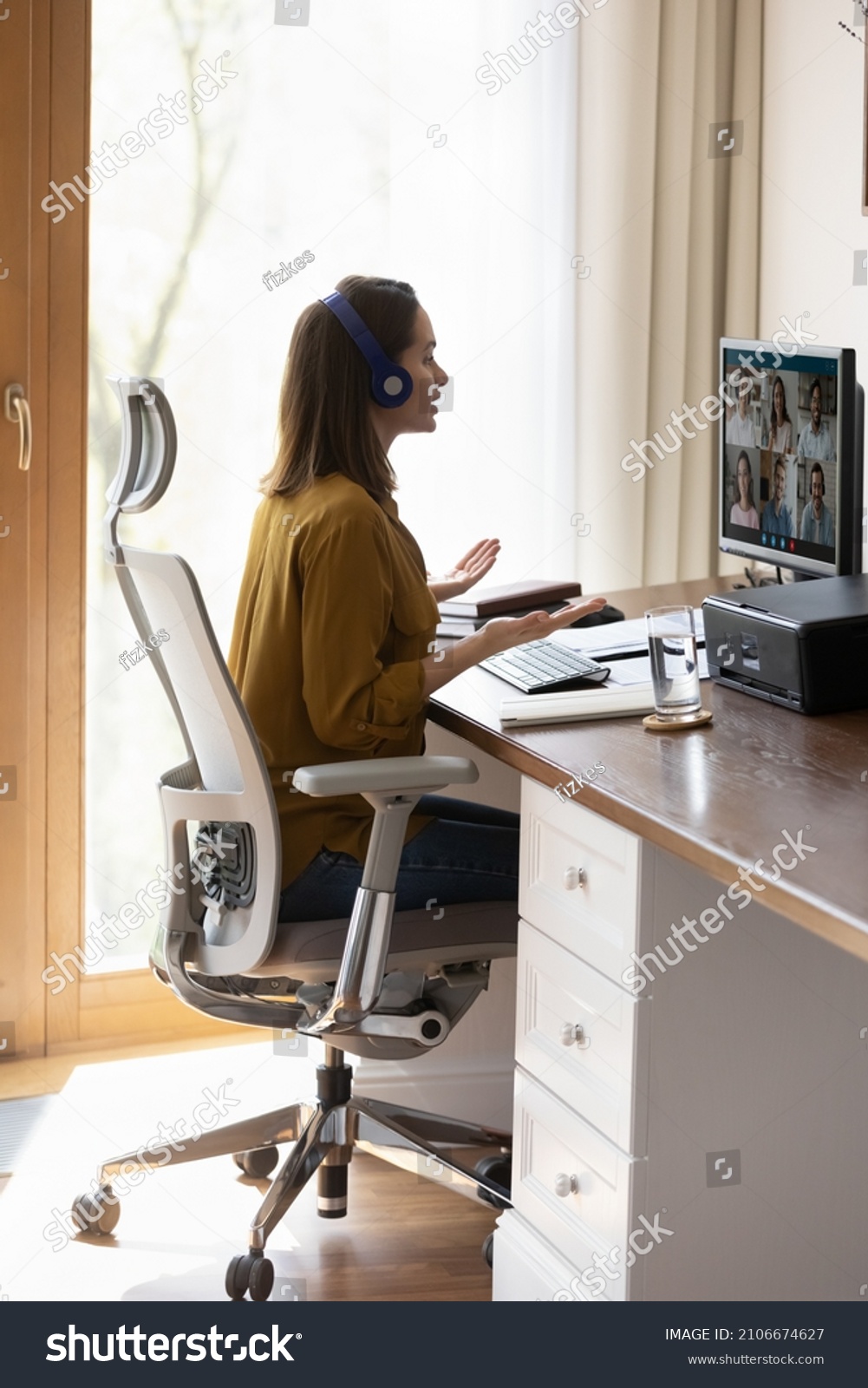 Millennial student, intern girl in headphones watching learning webinar, attending virtual online training, studying at home. Business woman, employee talking to team on video call, conference chat #2106674627