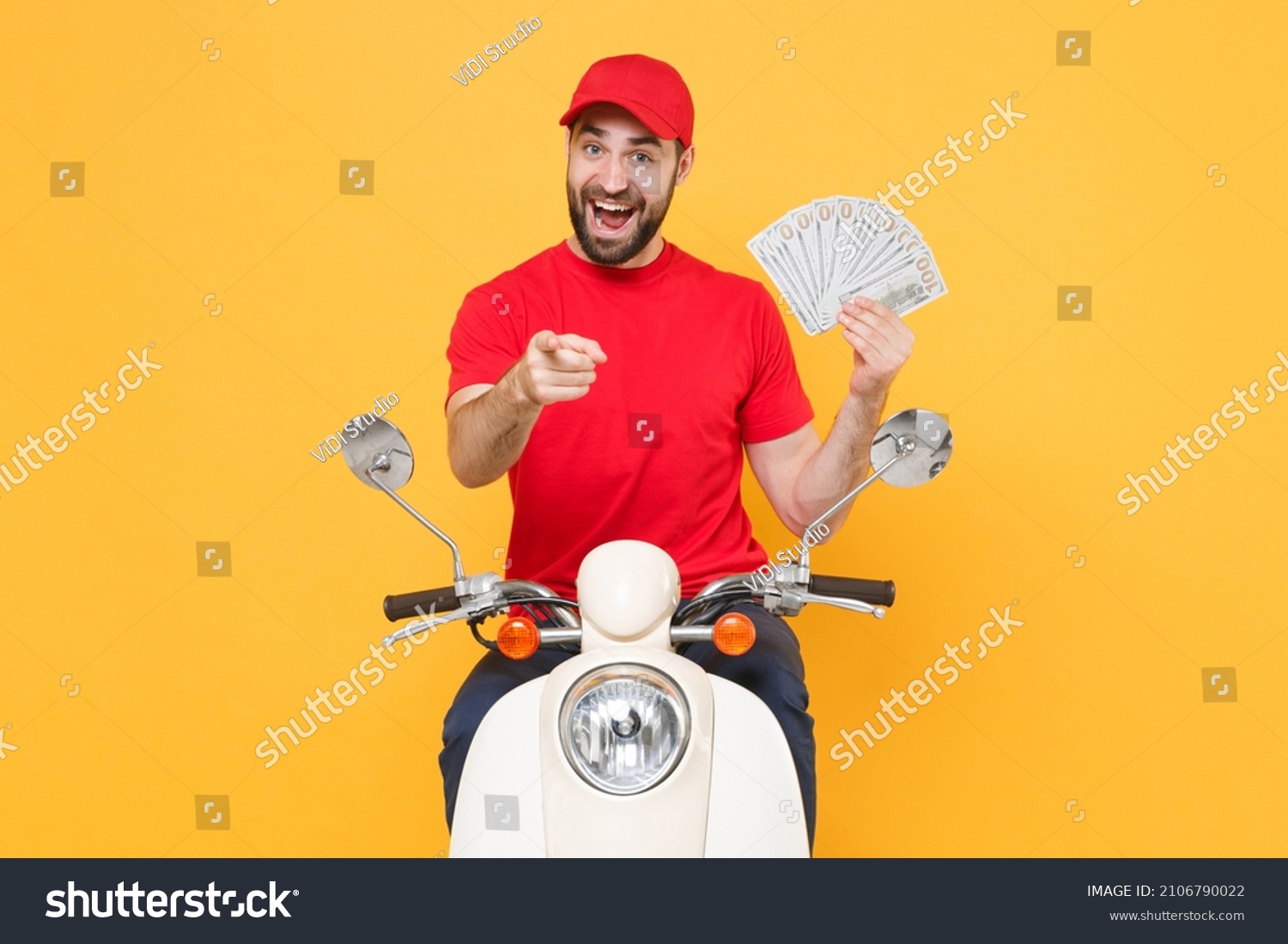 Delivery man in red cap t-shirt uniform driving moped motorbike scooter hold cash money isolated on yellow background studio Guy employee working courier Service quarantine pandemic covid-19 concept. #2106790022