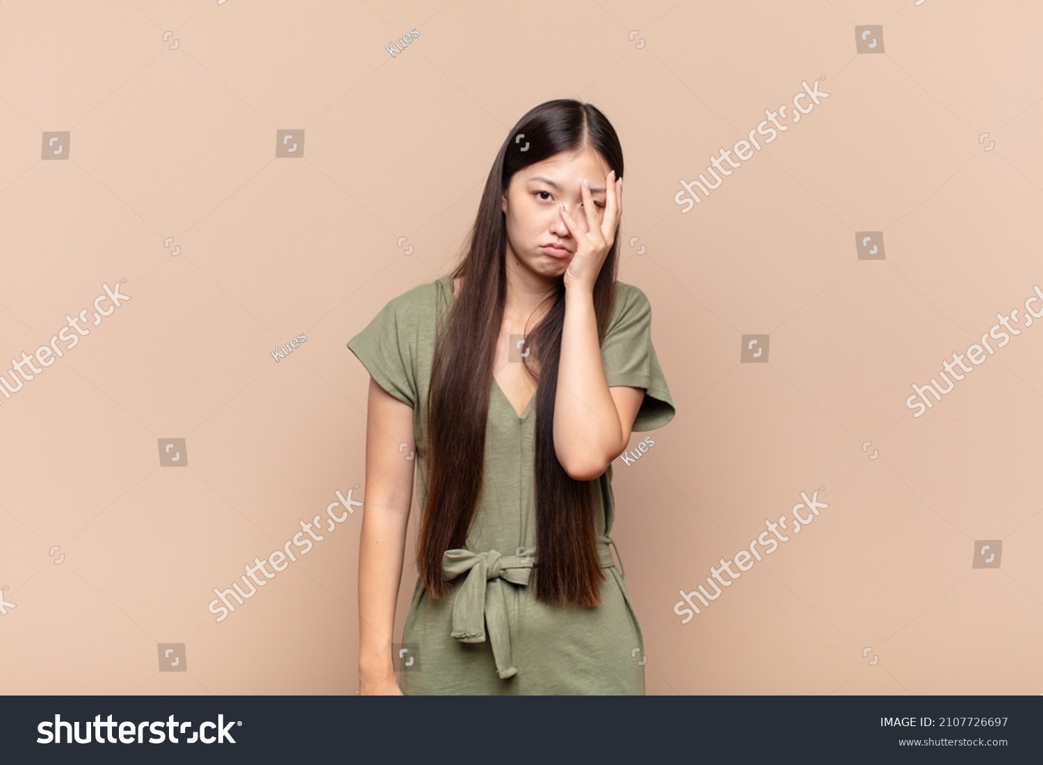 asian young woman feeling bored, frustrated and sleepy after a tiresome, dull and tedious task, holding face with hand #2107726697
