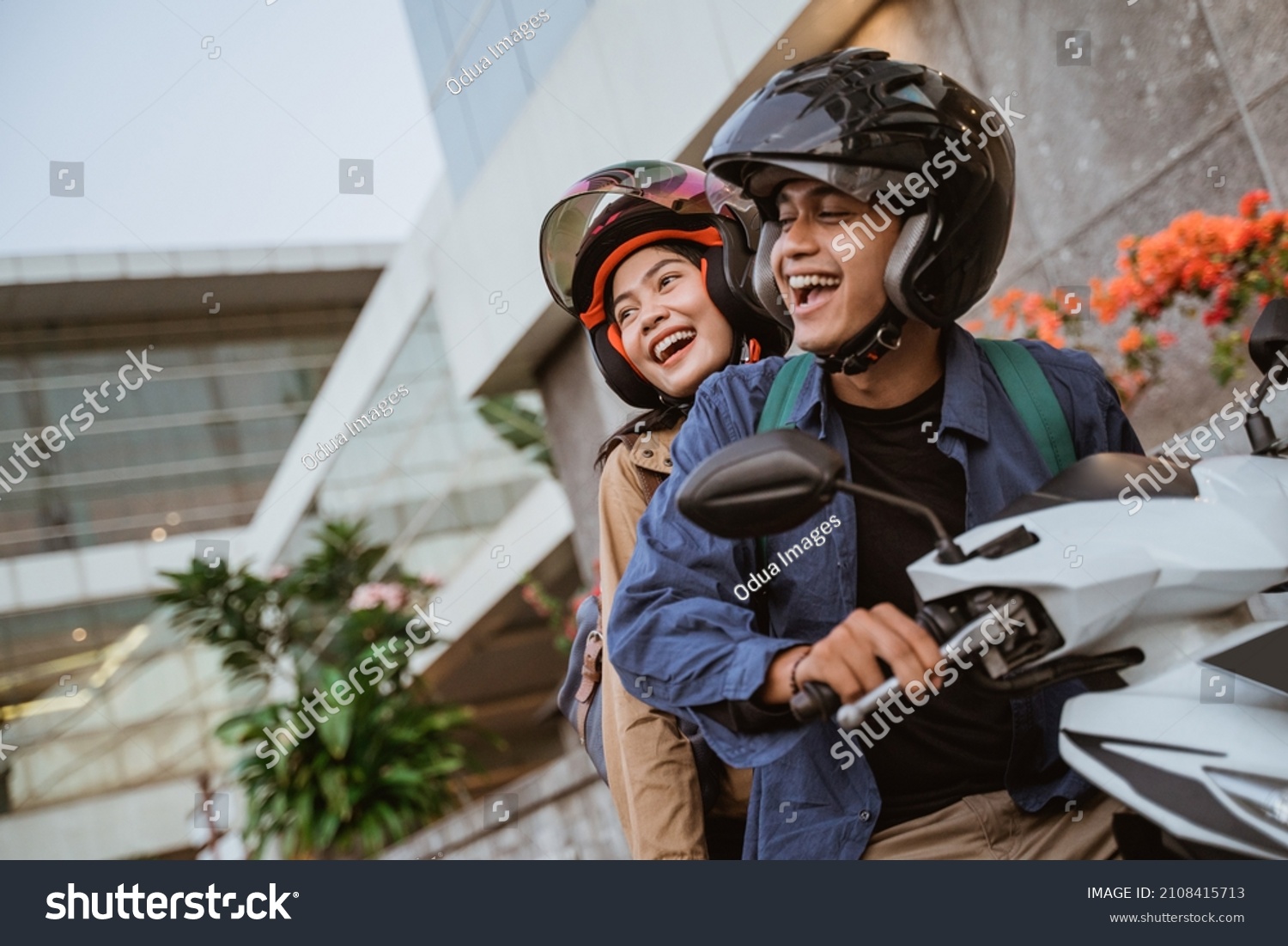 happy asian man and woman riding a motorcycle #2108415713