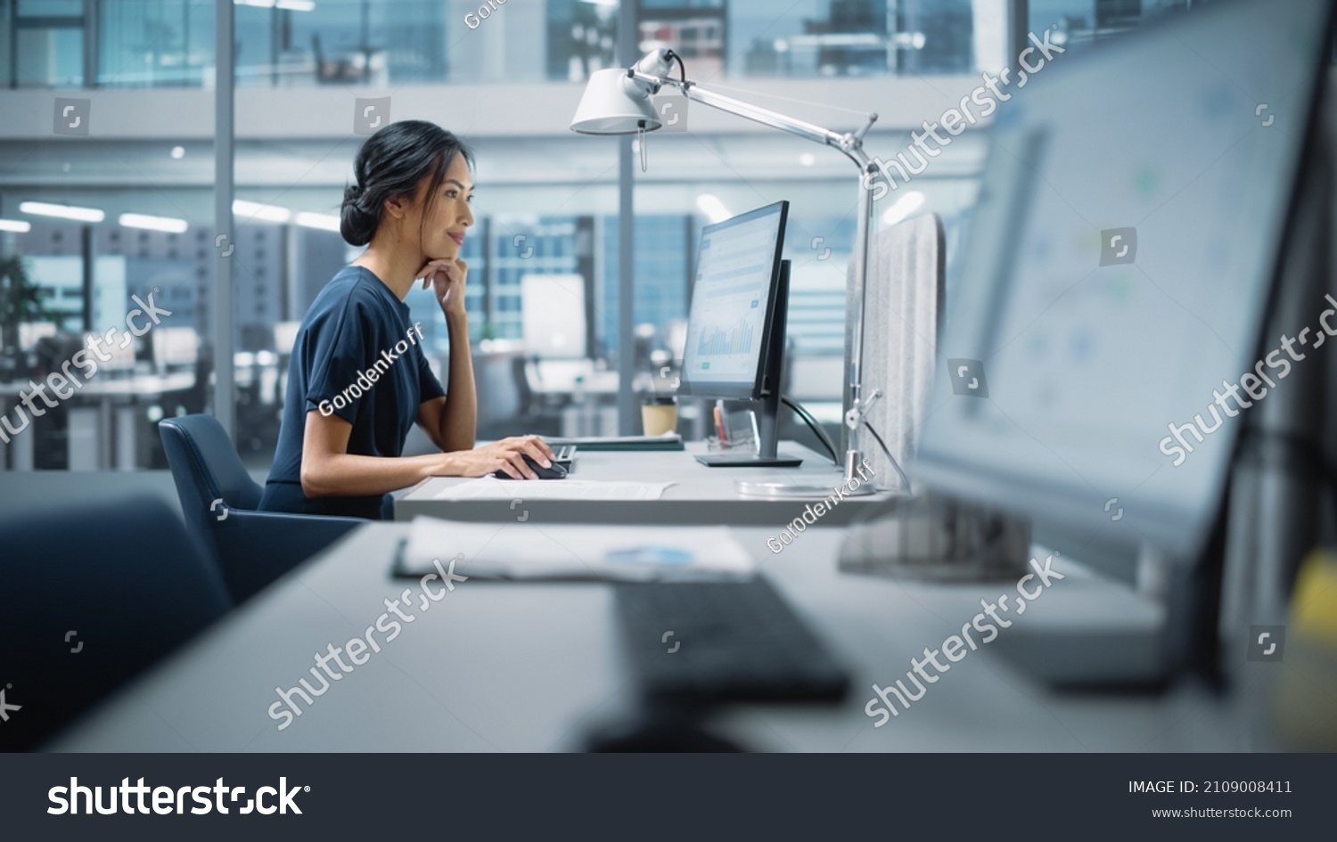 In Big Diverse Corporate Office: Portrait of Beautiful Asian Manager Using Desktop Computer, Businesswoman Managing Company Operations, Analysing Statistics, Commerce Data, Marketing Plans. #2109008411