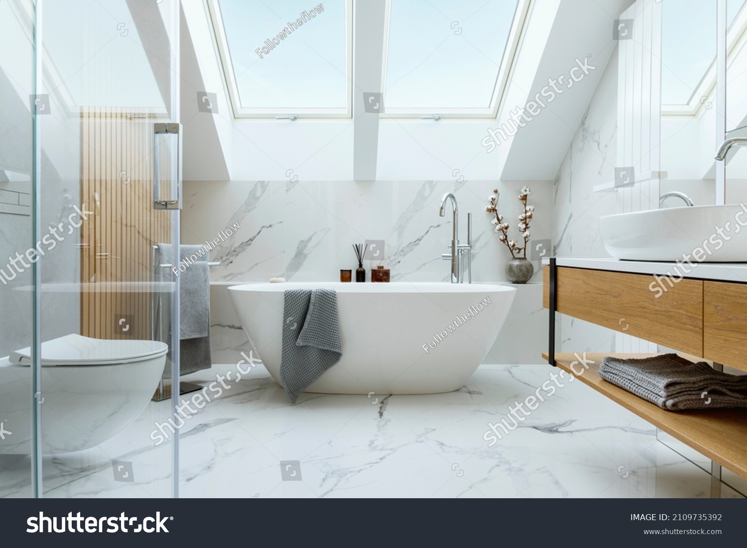 Stylish bathroom interior design with marble panels. Bathtub, towels and other personal bathroom accessories. Modern glamour interior concept. Roof window. Template. #2109735392