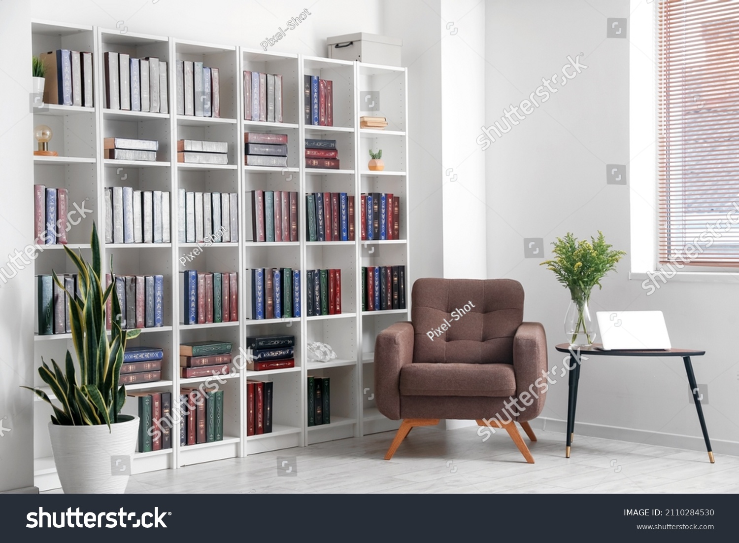 Bookcase with armchair in modern interior of room #2110284530