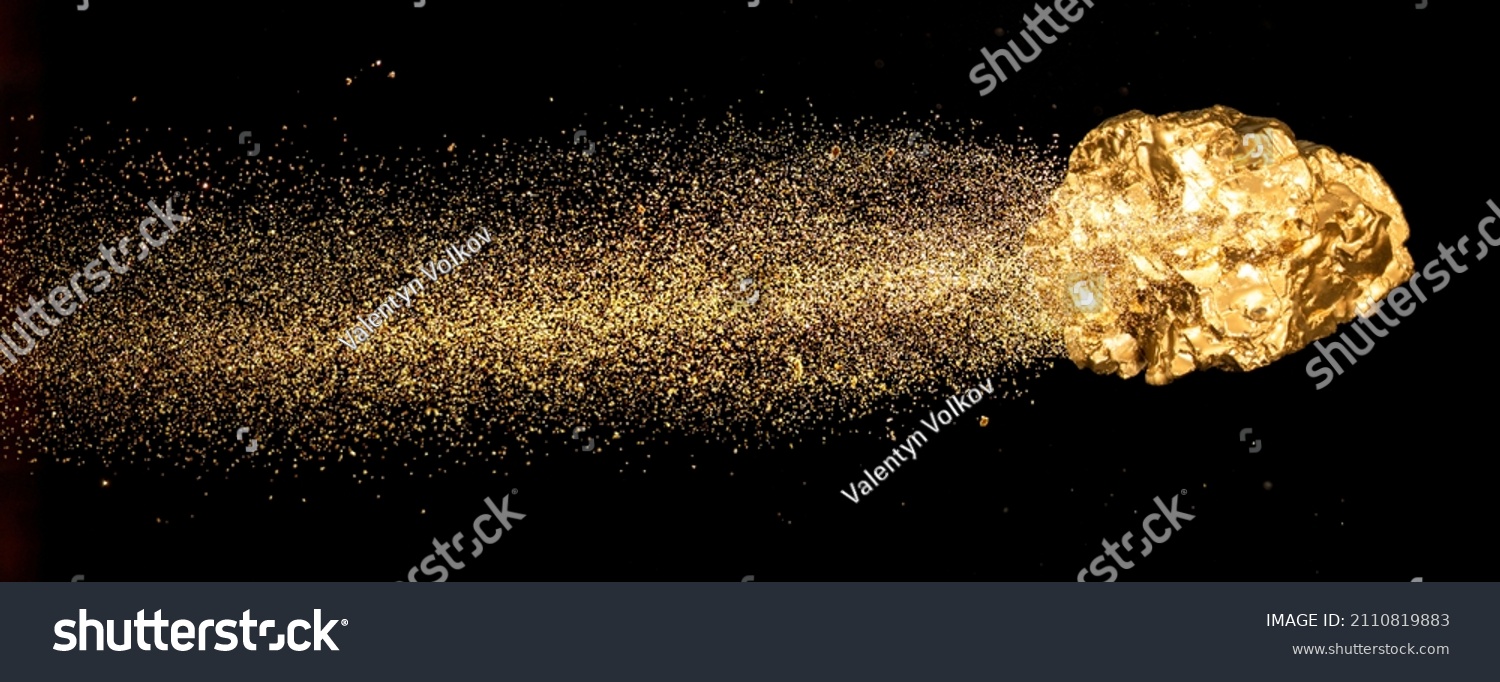 Piece of gold or golden nugget with visible gold shining comet tail ath the dark background.  #2110819883