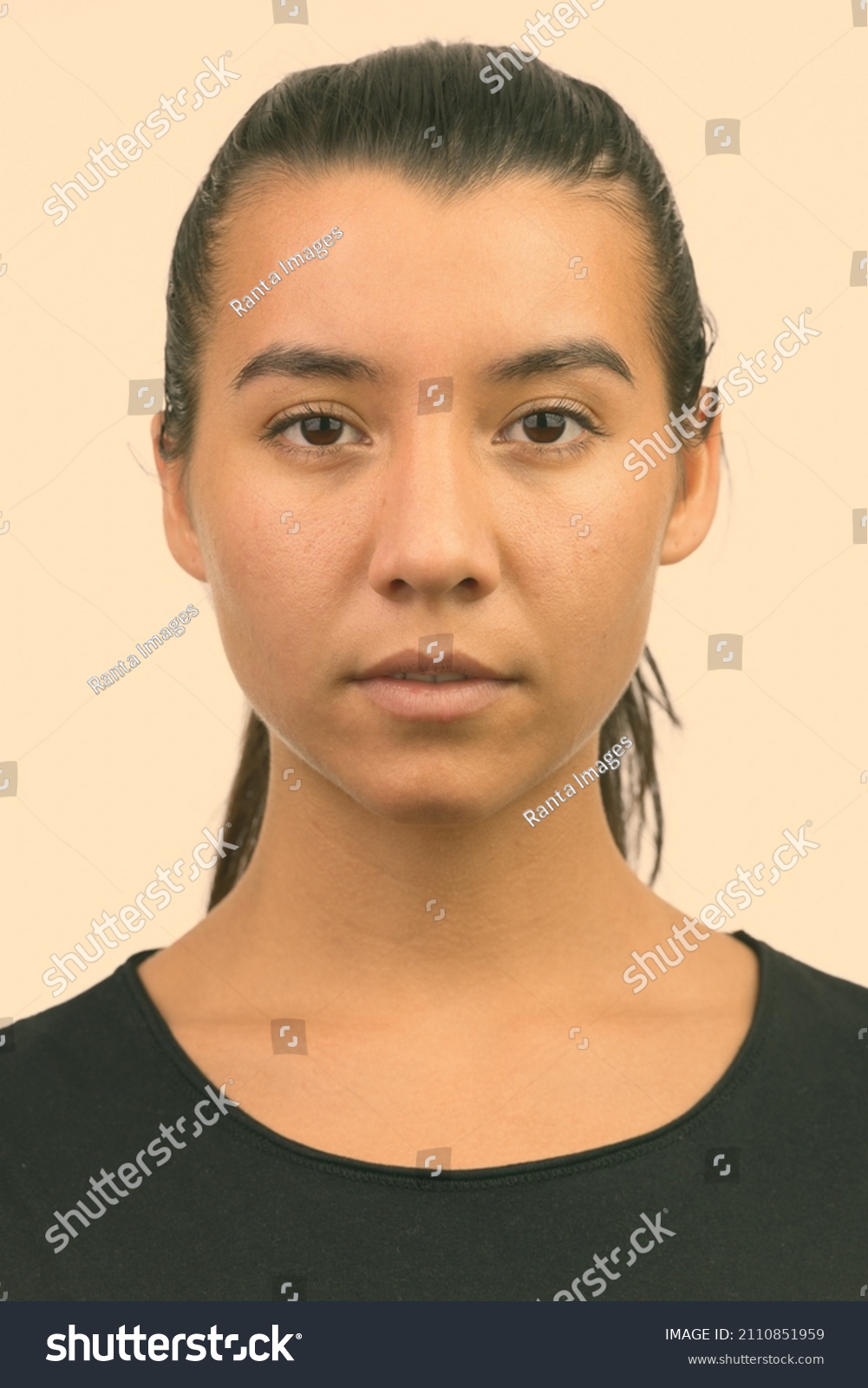 Portrait of young beautiful woman shot against studio background #2110851959