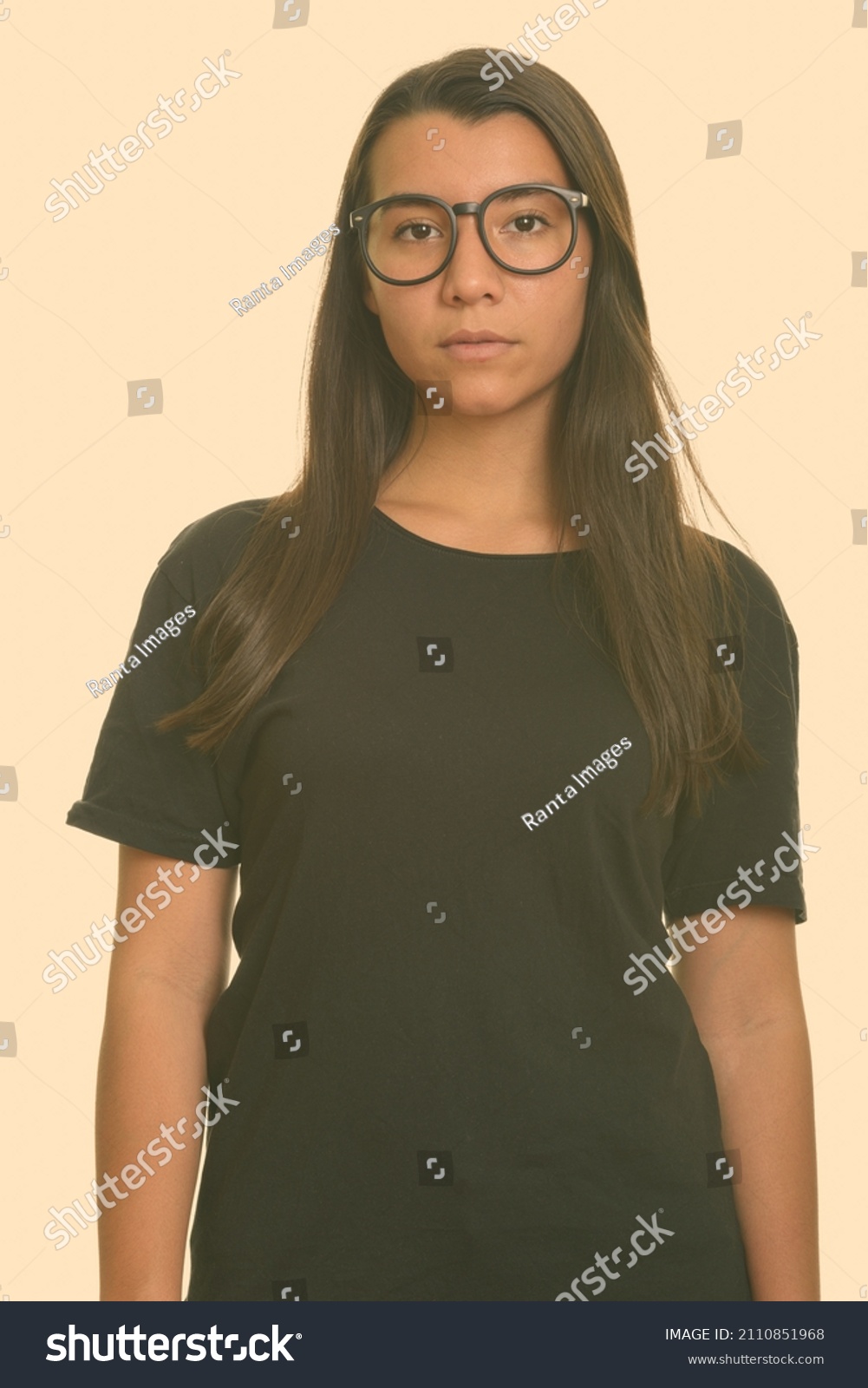 Portrait of young beautiful woman shot against studio background #2110851968