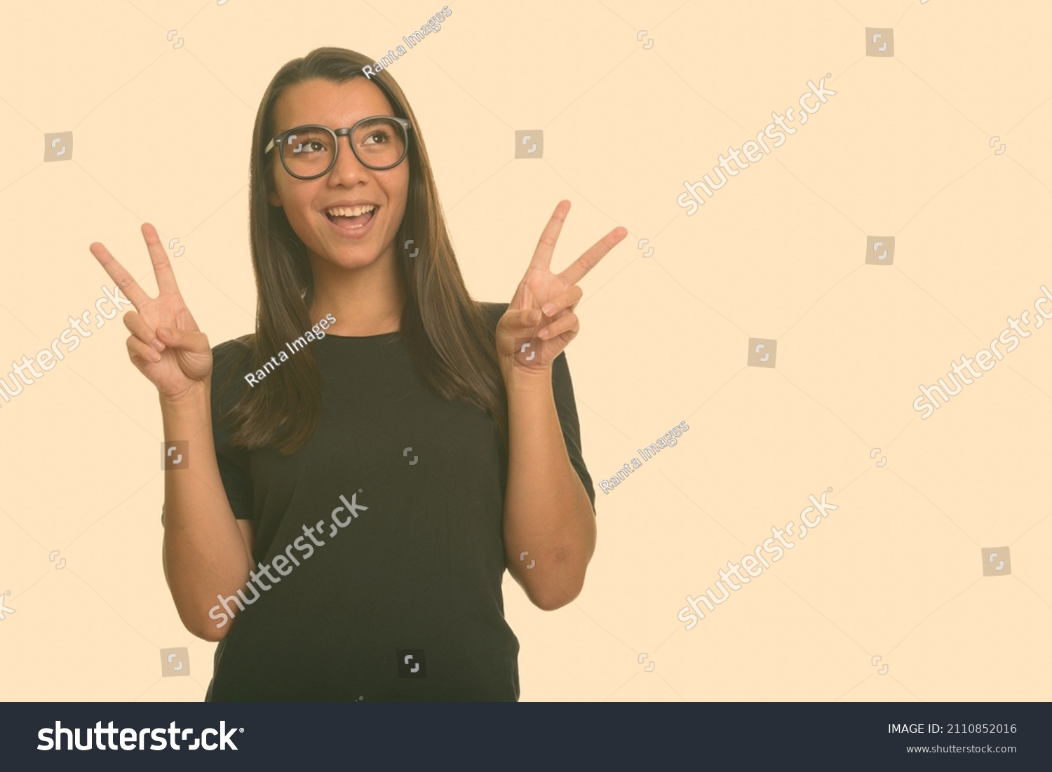 Portrait of young beautiful woman shot against studio background #2110852016