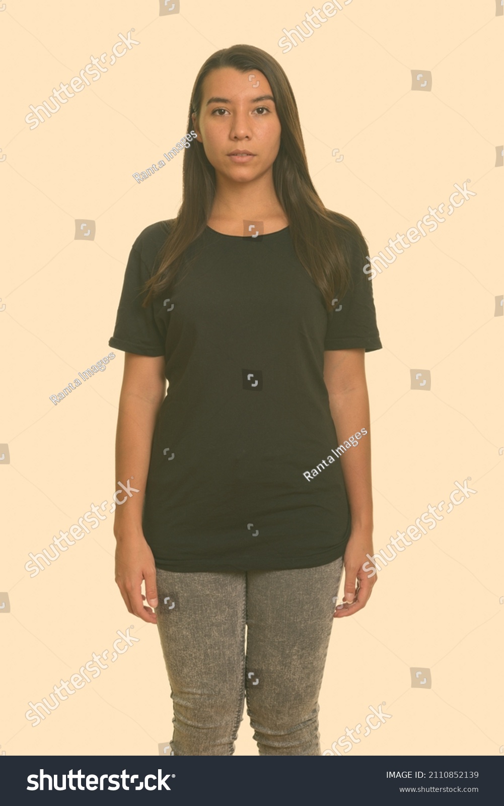 Portrait of young beautiful woman shot against studio background #2110852139