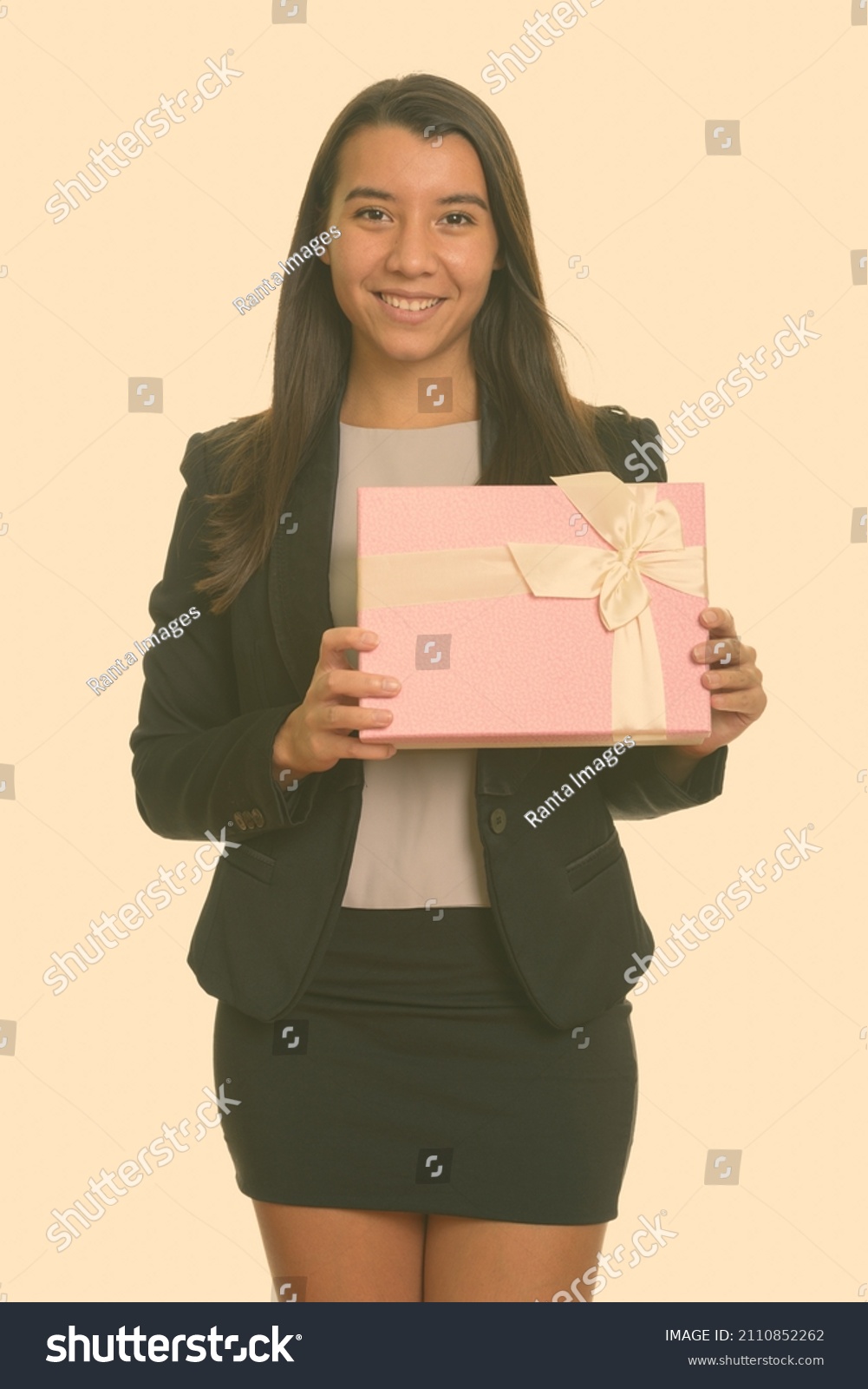 Portrait of young beautiful woman shot against studio background #2110852262