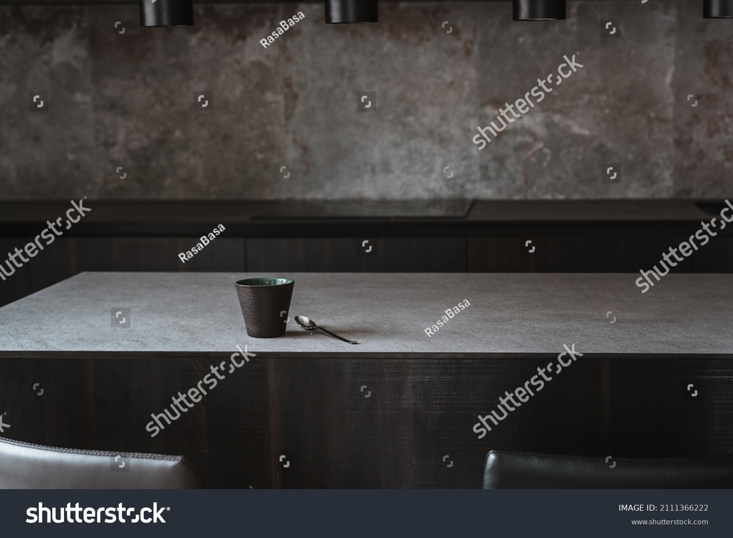 Beautiful coffee cup on island or table countertop in modern home kitchen. Dark grey kitchen design - detail of interior. #2111366222