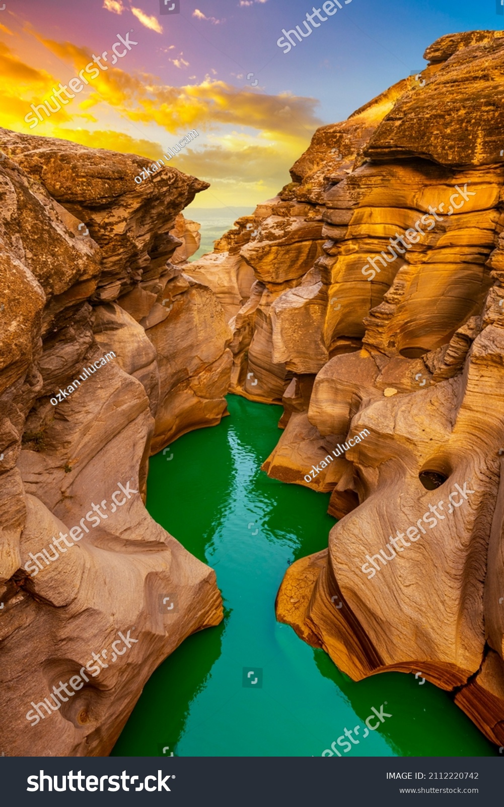 the river flowing through the valley of huge red rocks. Canyon view at sunset. extraordinary natural scenery. Nature landscape in the canyon. View of the stream flowing from the valley. #2112220742