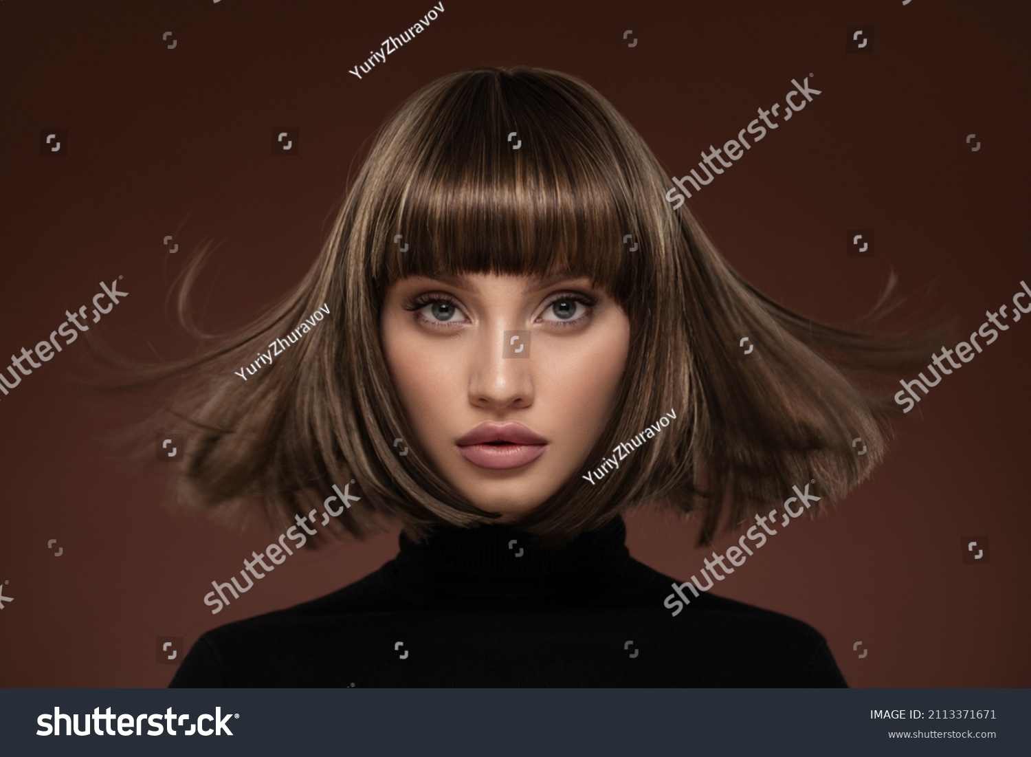 Portrait of a beautiful brown-haired woman with a short haircut on a brown background #2113371671