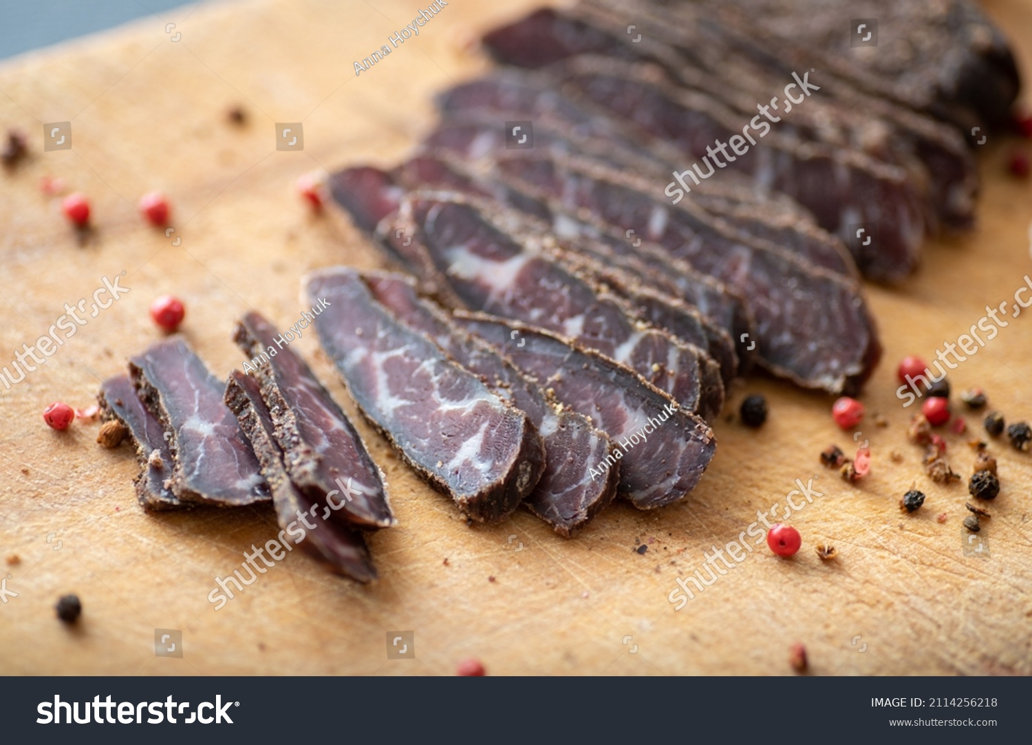 Thinly Sliced Simple Beef Biltong on Wooden Cutting Board #2114256218