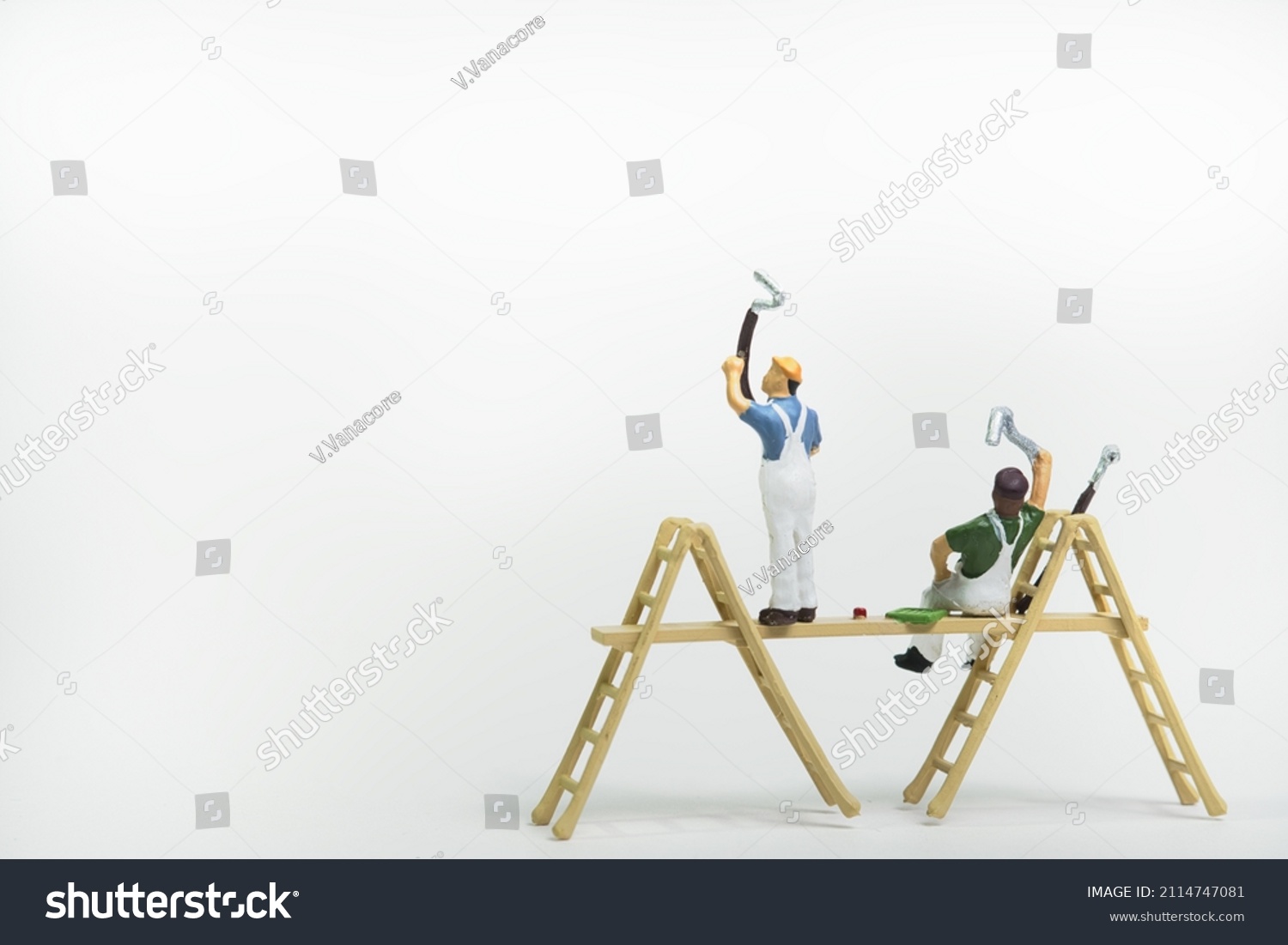 A team of painters on a scaffolding isolated on white background #2114747081