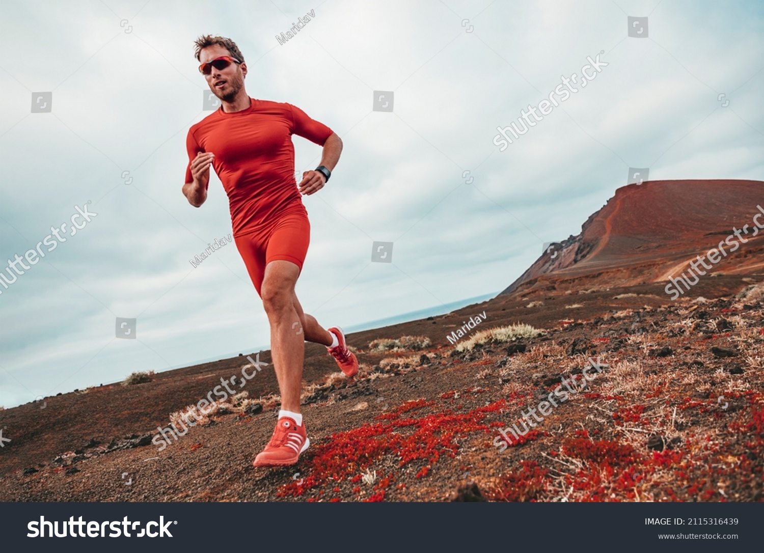 Running marathon man runner sport athlete training ultra running on long distance endurance trail race wearing compression clothes, sunglasses smartwatch wearable device. #2115316439