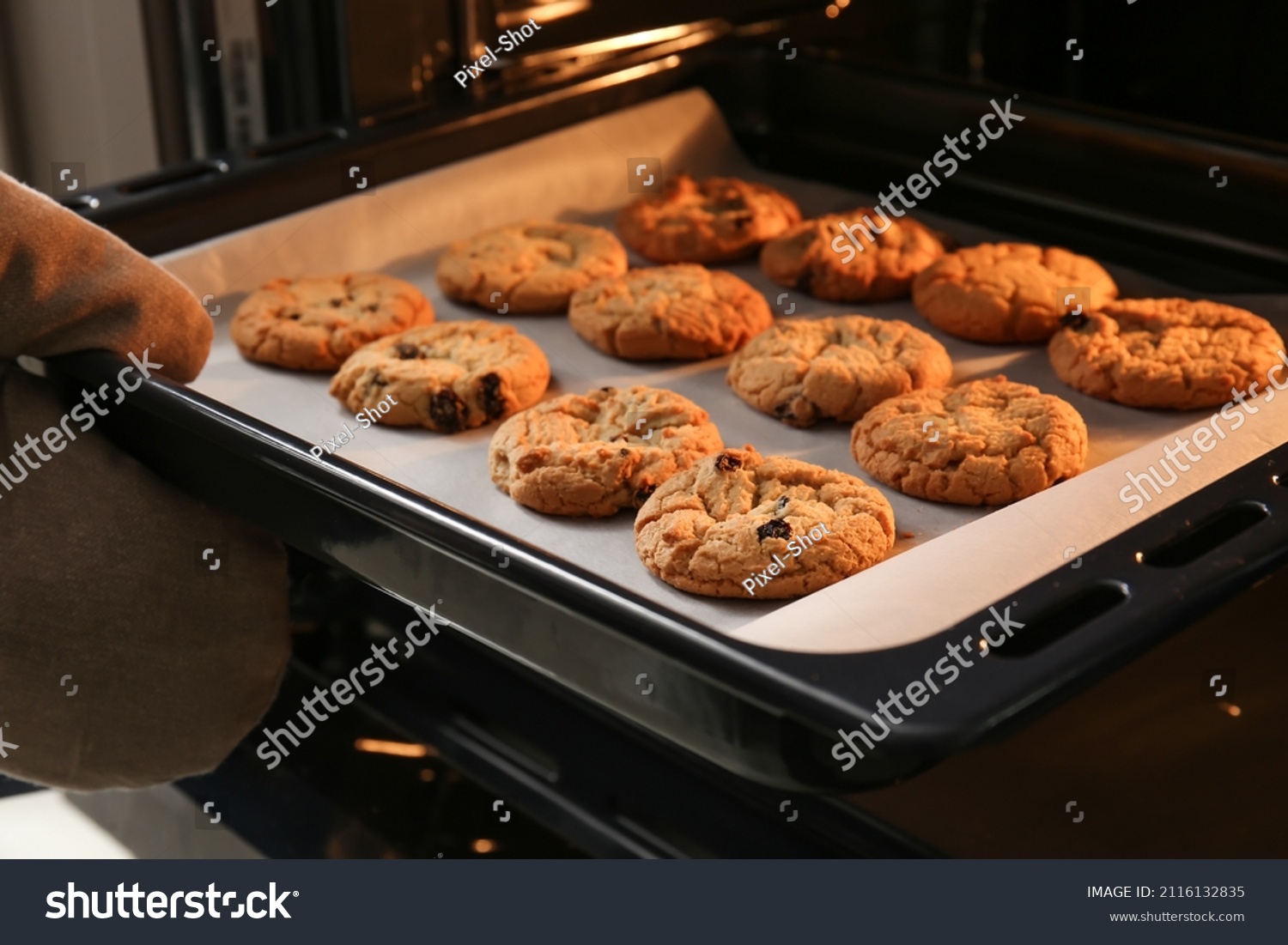 Baking tray with tasty homemade cookies taking out from oven #2116132835