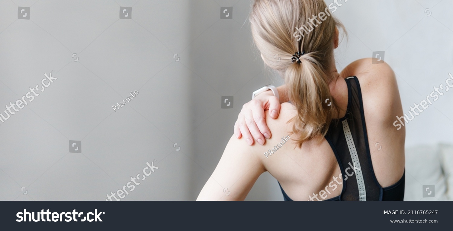 Woman with neck and back pain. Woman rubbing his painful back close up. Pain relief concept. #2116765247