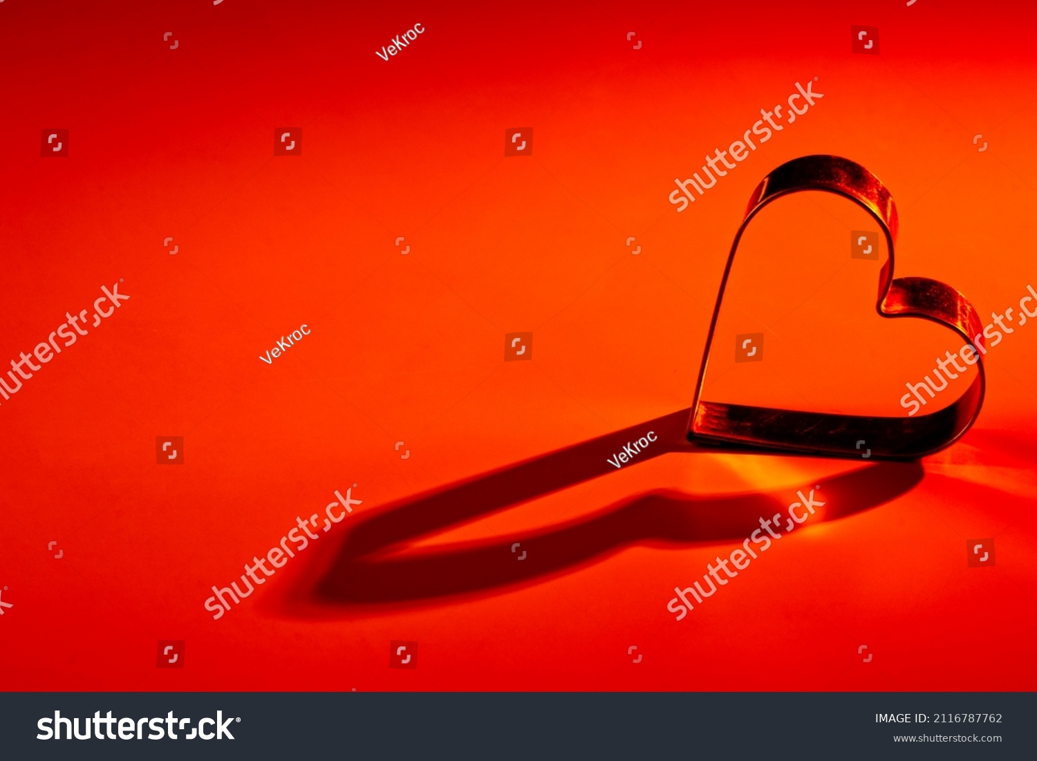 Red, orange yellow, gradient background. Metal heart. Lights and shadows. Love, wedding, Valentine 's day, engagement, romance, infatuation, marriage, fidelity, devotion, happiness, hot love, warmth. #2116787762
