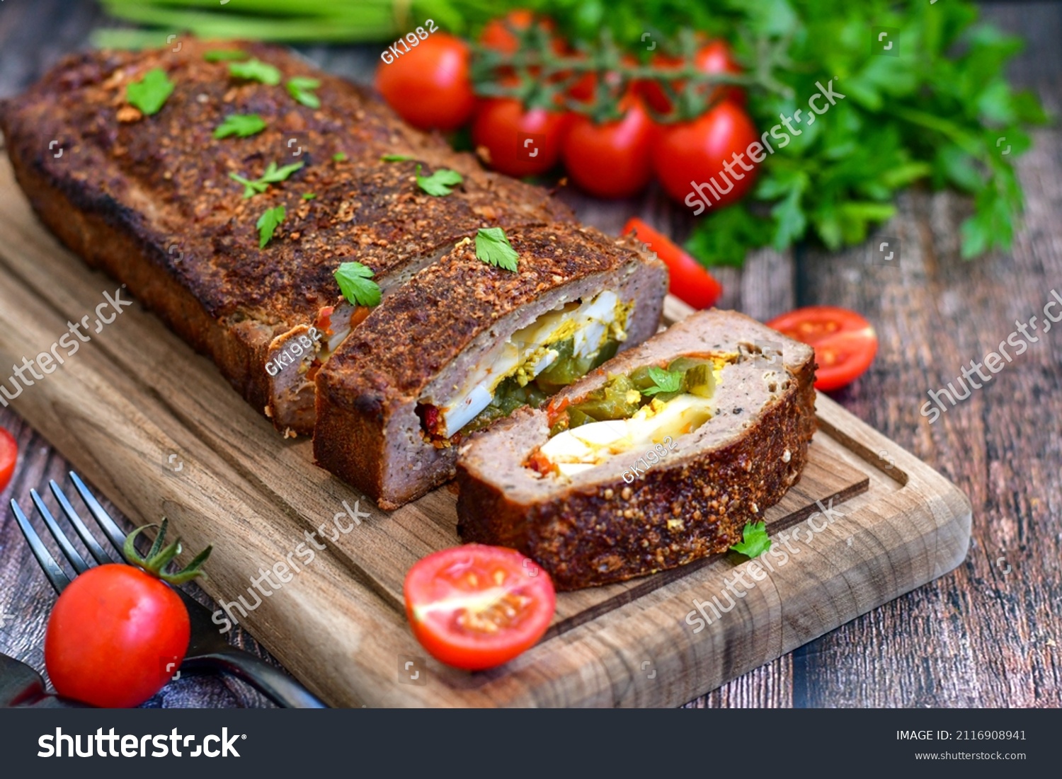 Home made baked  delicious  German meatloaf (Falscher Hase or Hackbraten) is a traditional pork and beef meat loaf bound with boiled eggs and cucumbers #2116908941