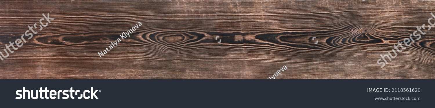 Aged, burned rustic braun dark pine wood texture. Boards with a knot. Grunge rough texture, wood texture. Scorched aged plank. Large size, banner #2118561620
