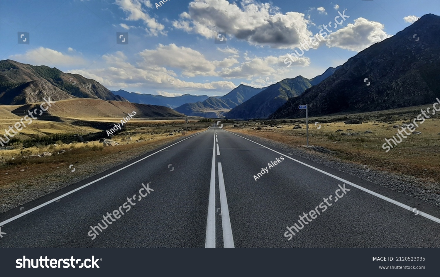 beautiful view of the paved road with road markings running in a mountainous area on a sunny autumn day #2120523935