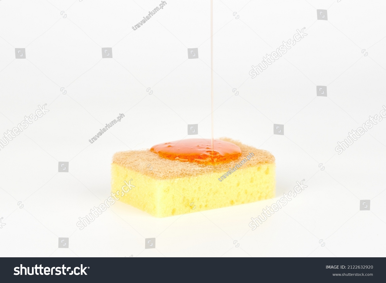 Pouring orange detergent on sponge isolated on white background. Orange liquid dish soap on sponge, home cleaning concept. Dishwashing sponge for general cleaning day #2122632920