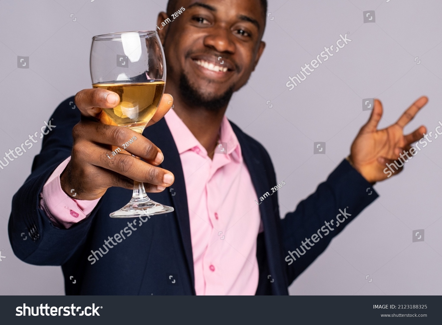 excited young black man raises a glass of wine #2123188325
