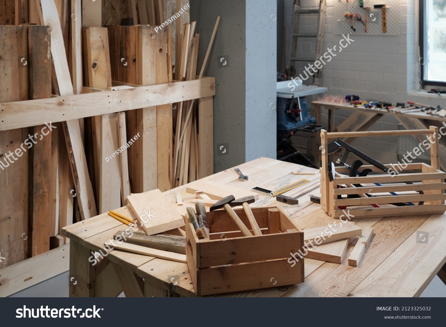 Background image of carpentry workshop with focus on wooden tool boxes in foreground, copy space #2123325032