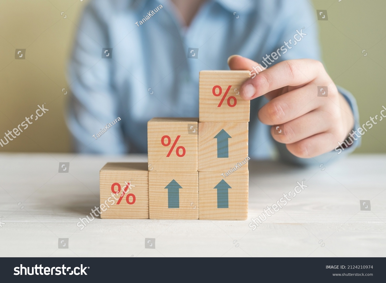 Interest rate financial and mortgage rates concept. Hand putting wood cube block increasing on top with icon percentage symbol and arrow upward direction #2124210974