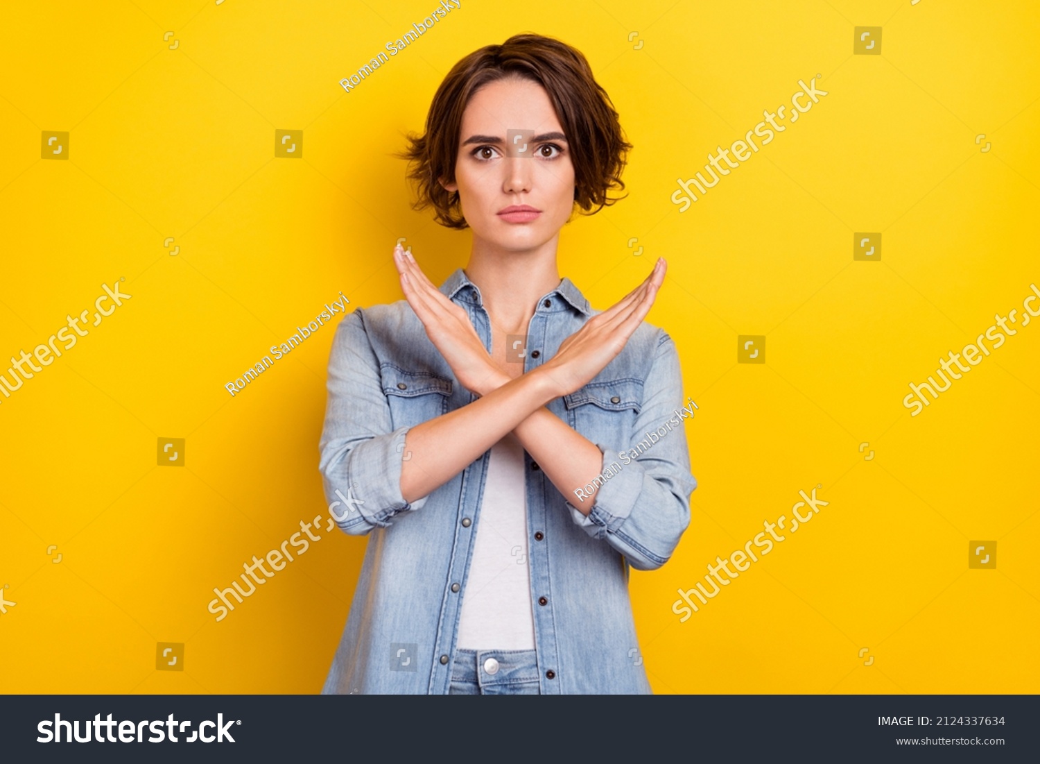 Photo of young pretty serious woman crossed hands show no stop forbidden symbol isolated over yellow color background #2124337634