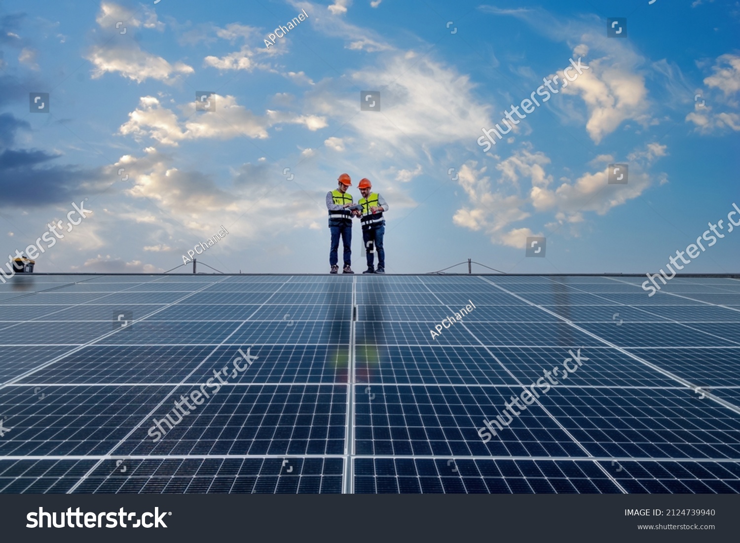Engineers walking on roof inspect and check solar cell panel by hold equipment box and radio communication ,solar cell is smart grid ecology energy sunlight alternative power factory concept. #2124739940