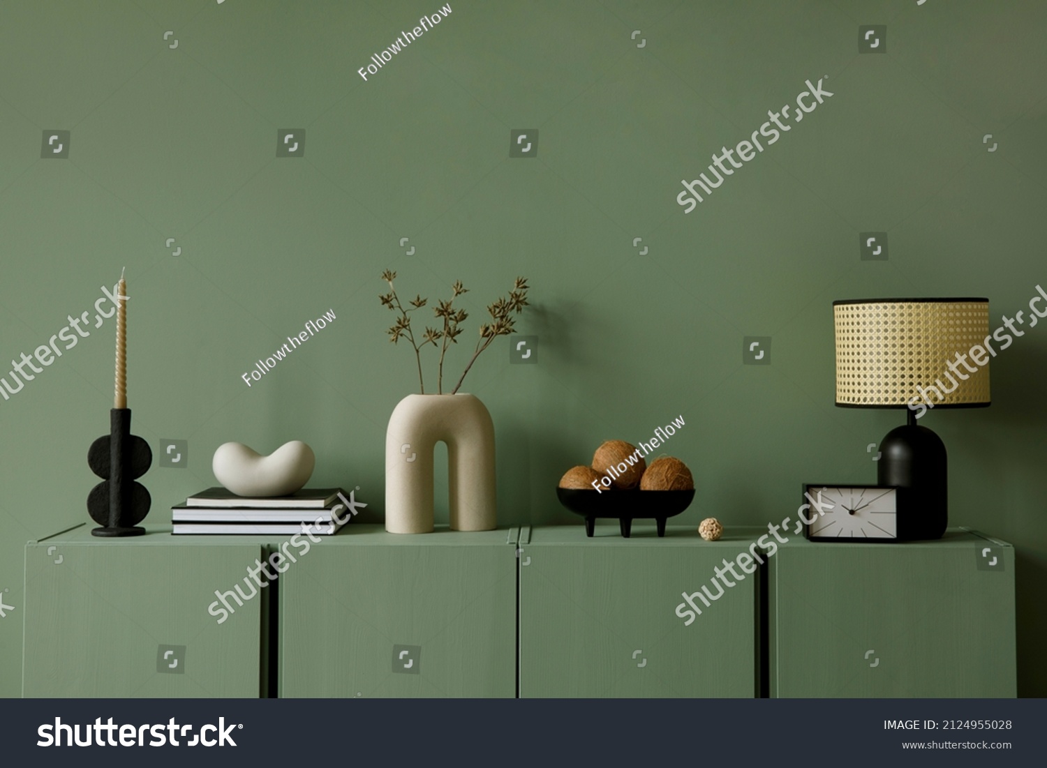 Modern living room interior composition with modern home decorations and personal accessories on the eucalyptus wooden commode. Eucalyptus wall. Template. Copy space. #2124955028