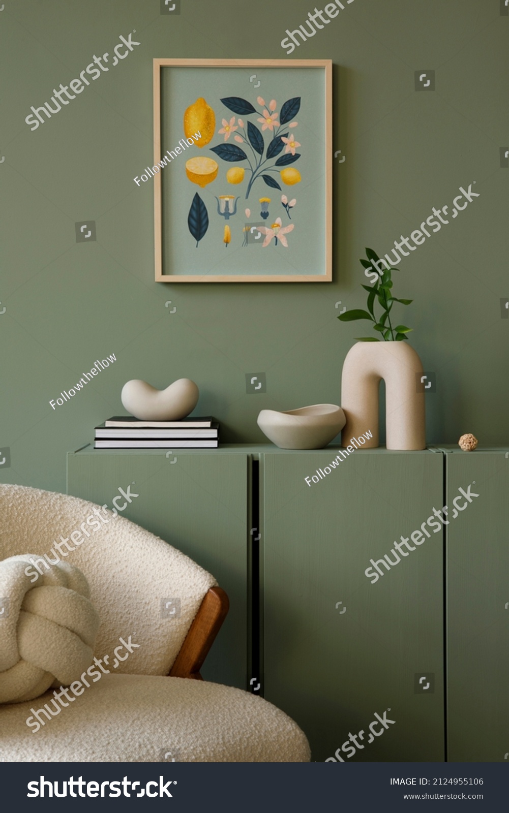 Elegant living room interior design with mockup poster frame, modern frotte armchair, wooden commode and stylish accessories. Eucalyptus wall. Template. Copy space. #2124955106