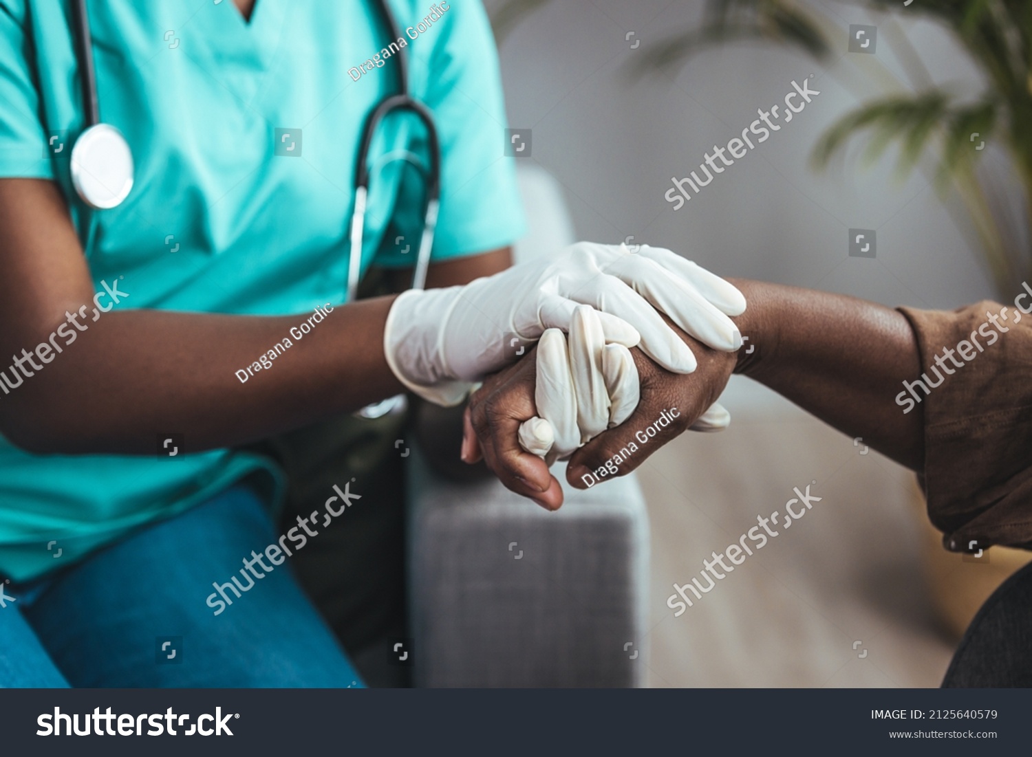 Cropped shot of a female nurse hold her senior patient's hand. Giving Support. Doctor helping old patient with Alzheimer's disease. Female carer holding hands of senior man #2125640579