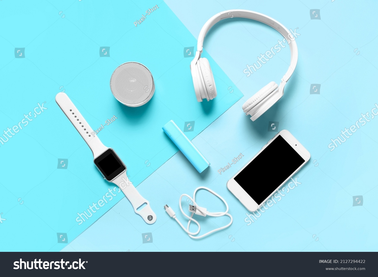 Modern gadgets with power bank on blue background #2127294422
