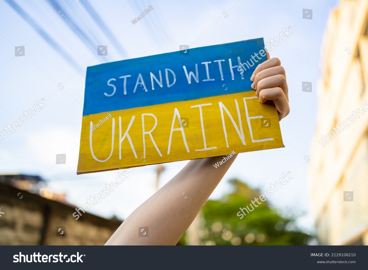 Demonstrator holding "Stand with Ukraine" placard #2129108210
