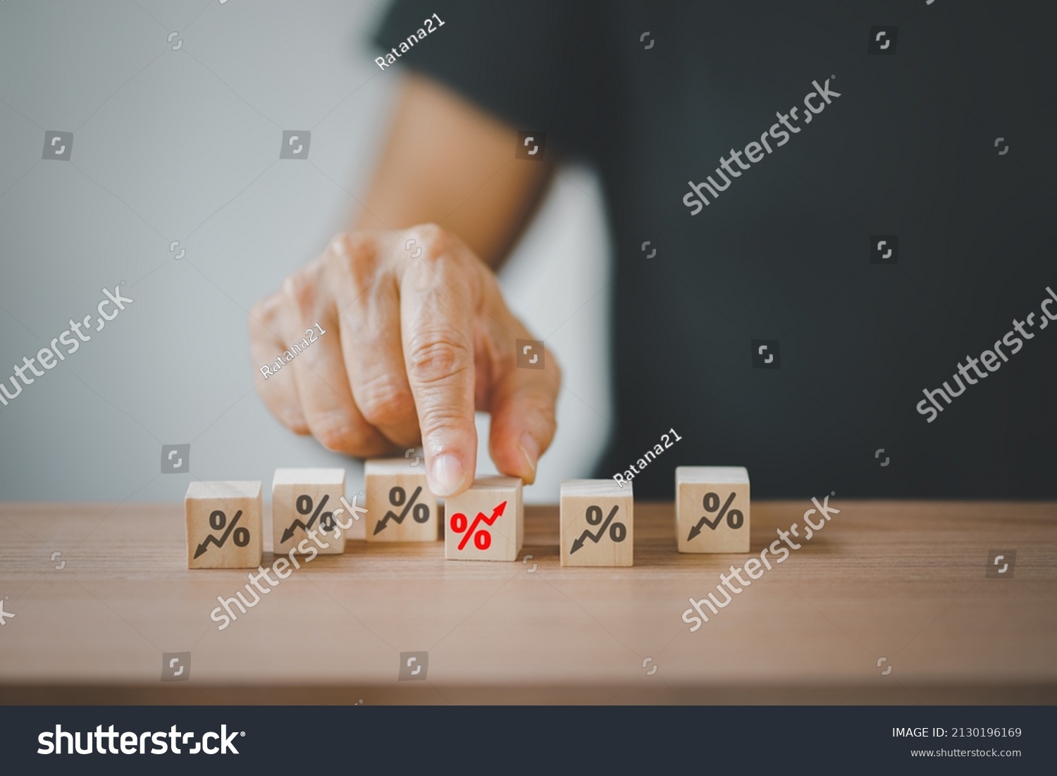 senior hand choosing red increasing percent among black decreasing percent on wooden desk, business development, increasing interest, payment, profit concept #2130196169