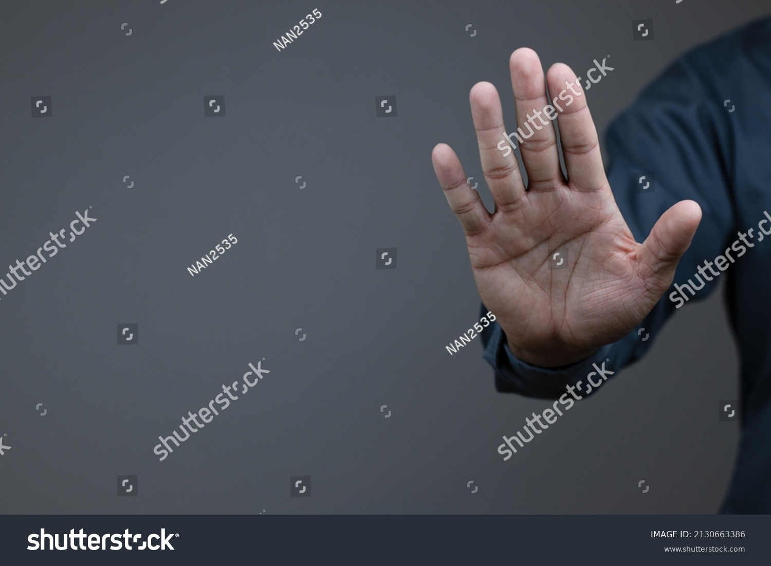man showing stop gesture reject on black background with empty space for text, copy space, close up of the hand, anti concept, rejection
 #2130663386
