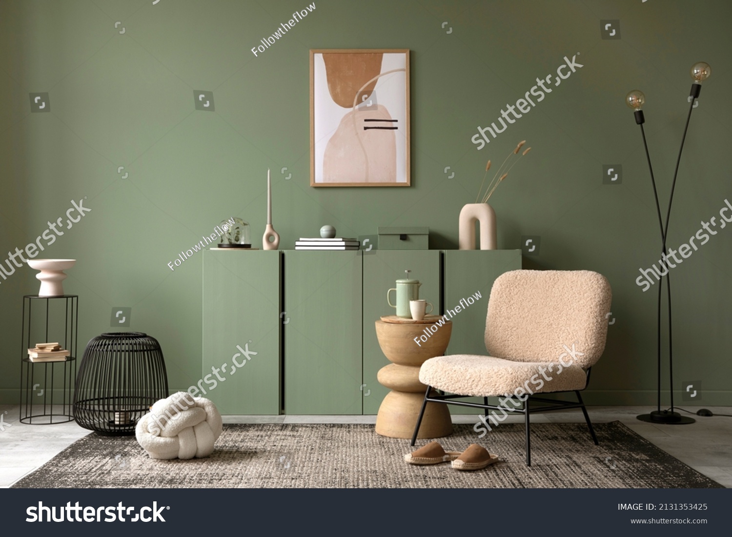 Stylish living room interior design with mock up poster frame, frotte armchair, wooden commode, side table, plants and creative home accessories. Sage green wall. Home staging. Template. Copy space. #2131353425