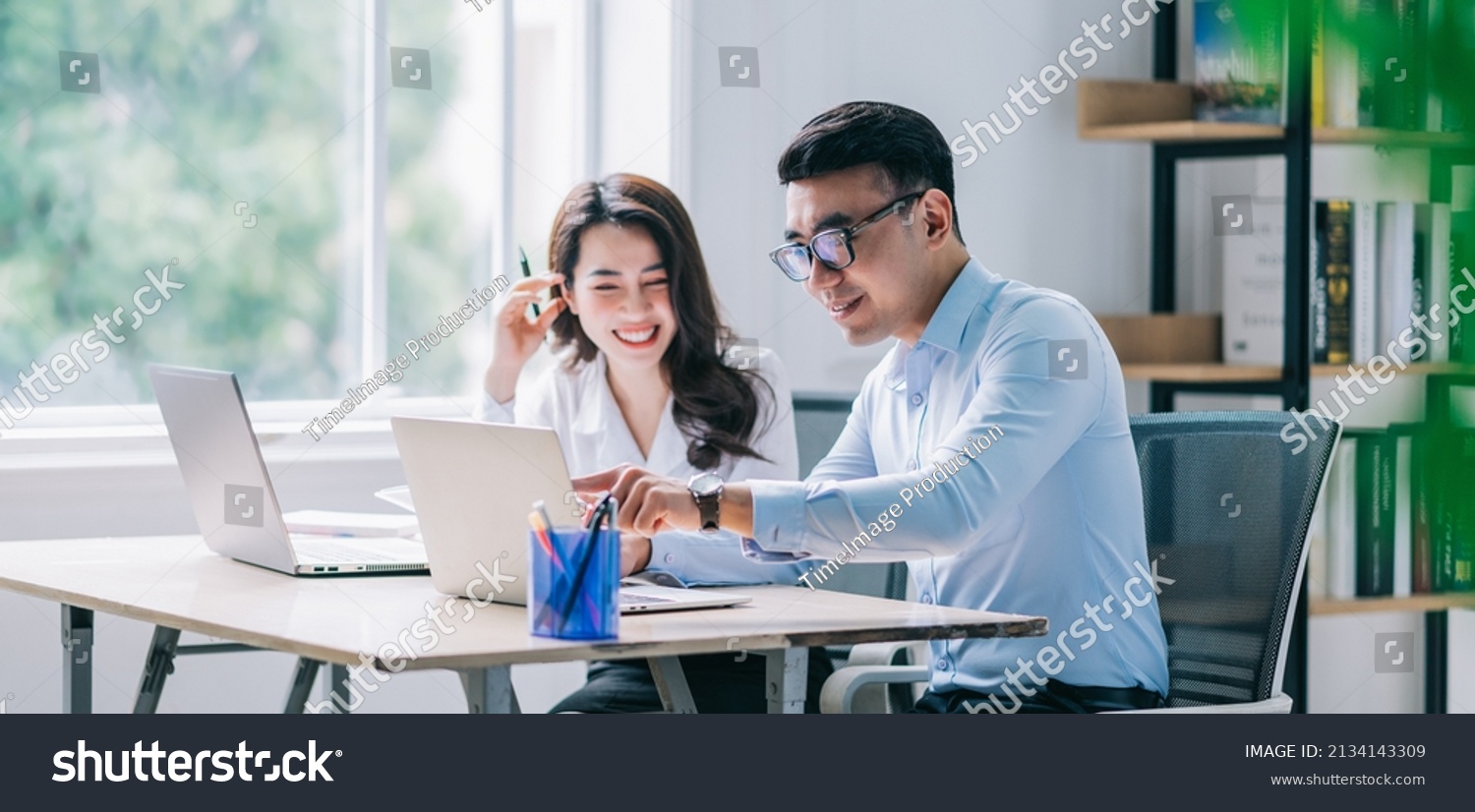 Two Asian businesspeople working at office #2134143309