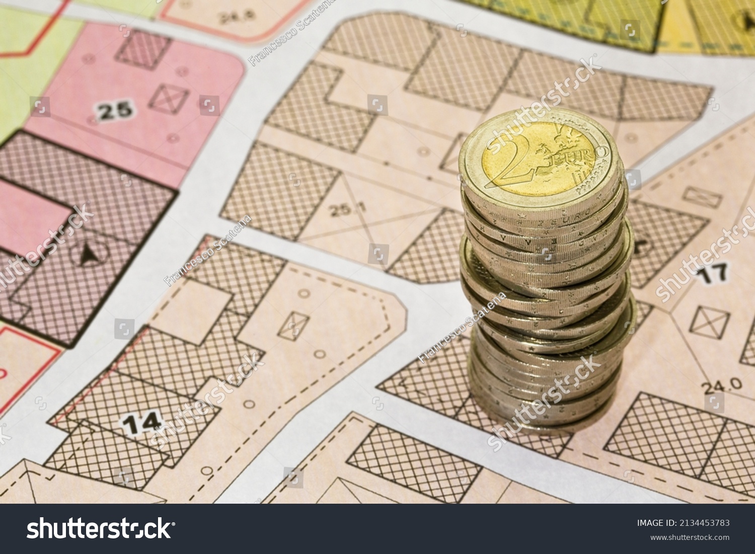 Land registry fees in European Union - concept with an imaginary cadastral map of territory with buildings, land parcel european euro coins #2134453783