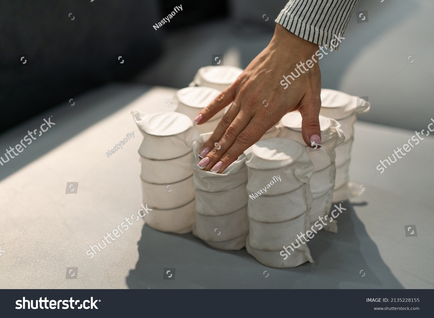 Independent spring blocks packed in spunbond. Bonding layers of springs. Furniture manufacture. Industrial and business concept. The concept of filling a mattress. #2135228155